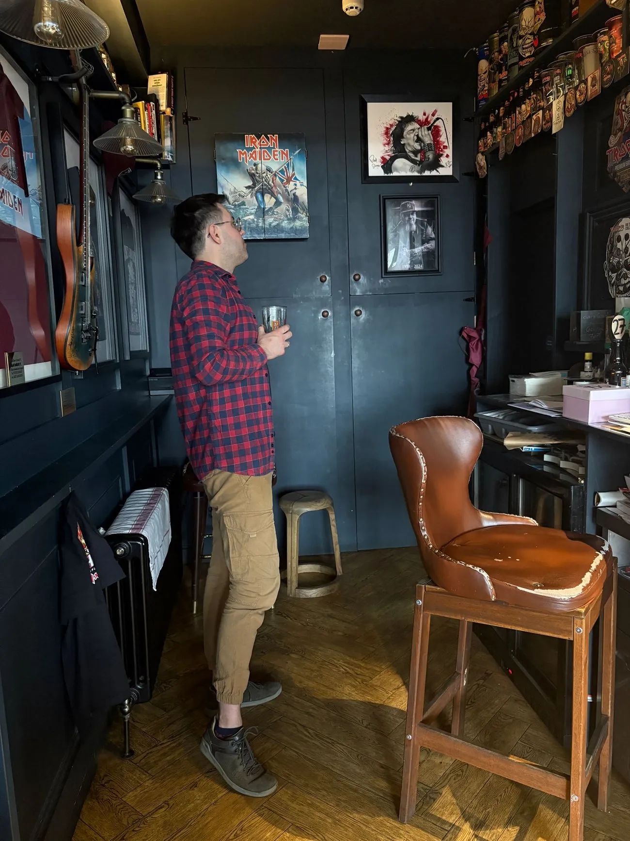 Wojtek at the Cart and Horses pub in Stratford, London, long known as the birthplace of Iron Maiden, with an Iron Maiden poster and memorabilia on the walls
